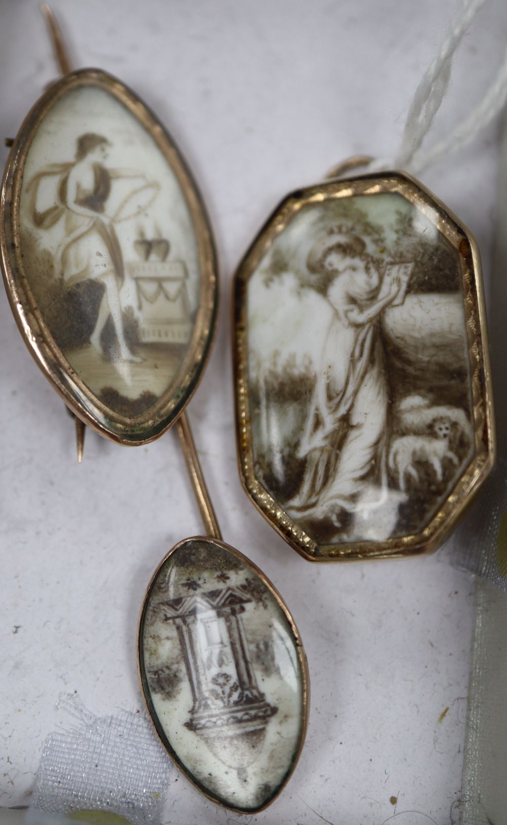 A Regency yellow metal and ivory panel set mourning brooch, 31mm and a similar pendant and stick pin.